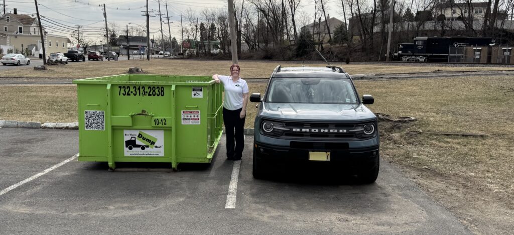 Woman next to 10 yd Dumpster