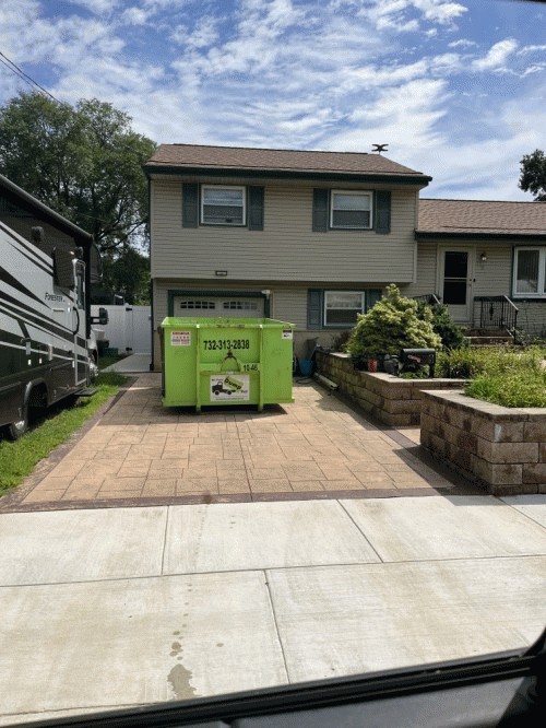 Residential-friendly 15-yard roll-off dumpster rental delivered to a driveway in Burlington County NJ