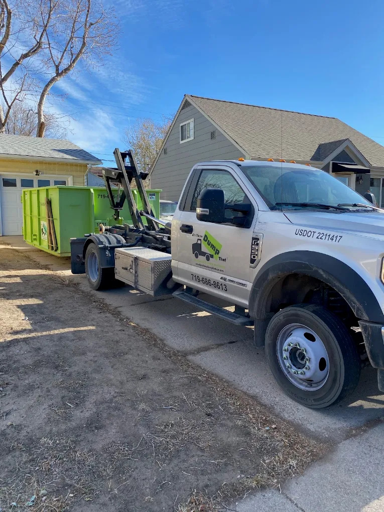 Bin There Dump That truck placing a residential friendly dumpster on a driveway