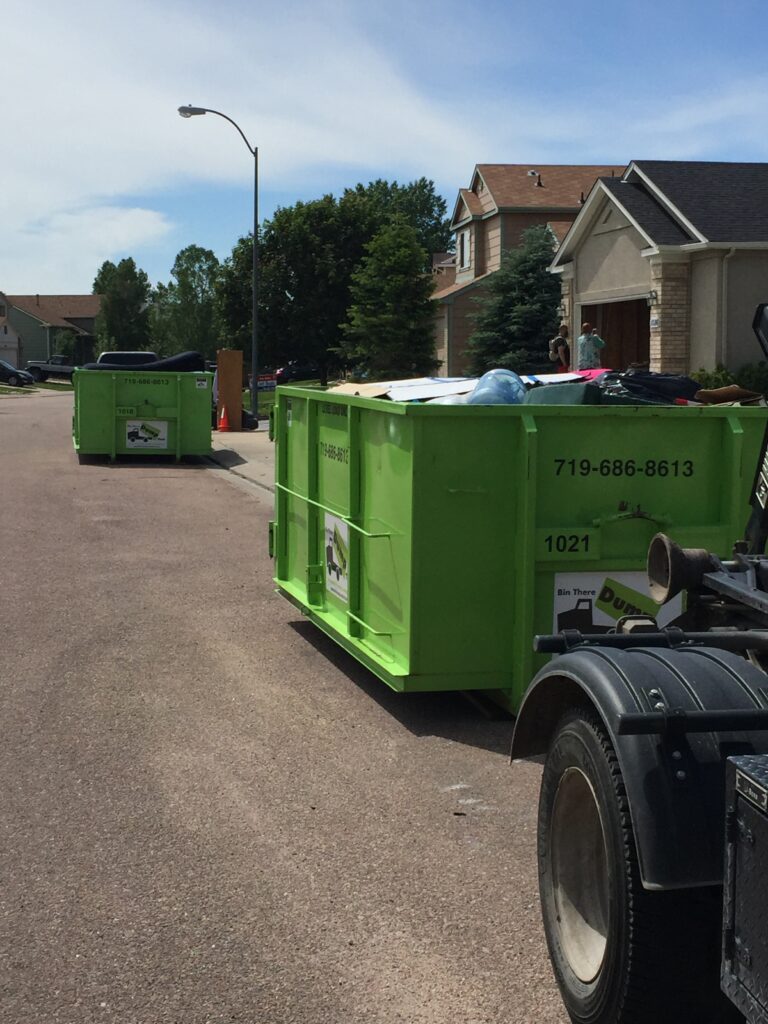 Dumpster loaded with furniture and household goods during a street cleanout
