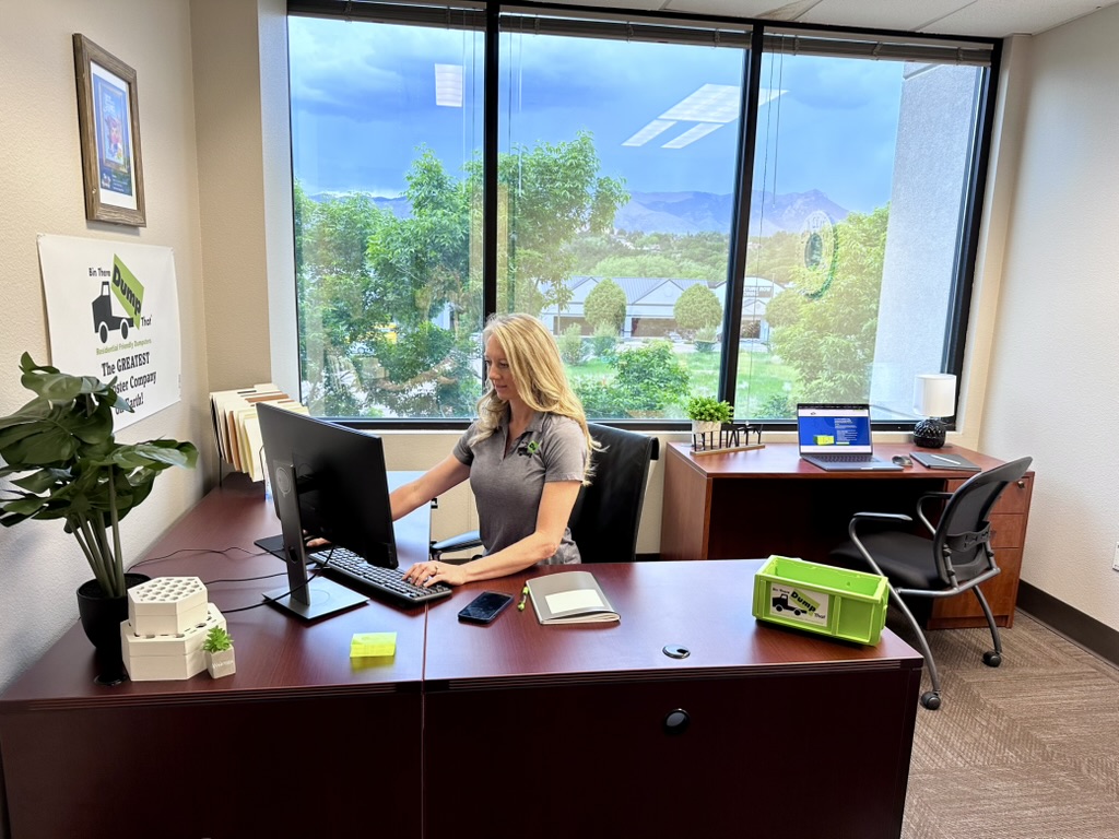 Office team member answering dumpster rental calls in Colorado Springs