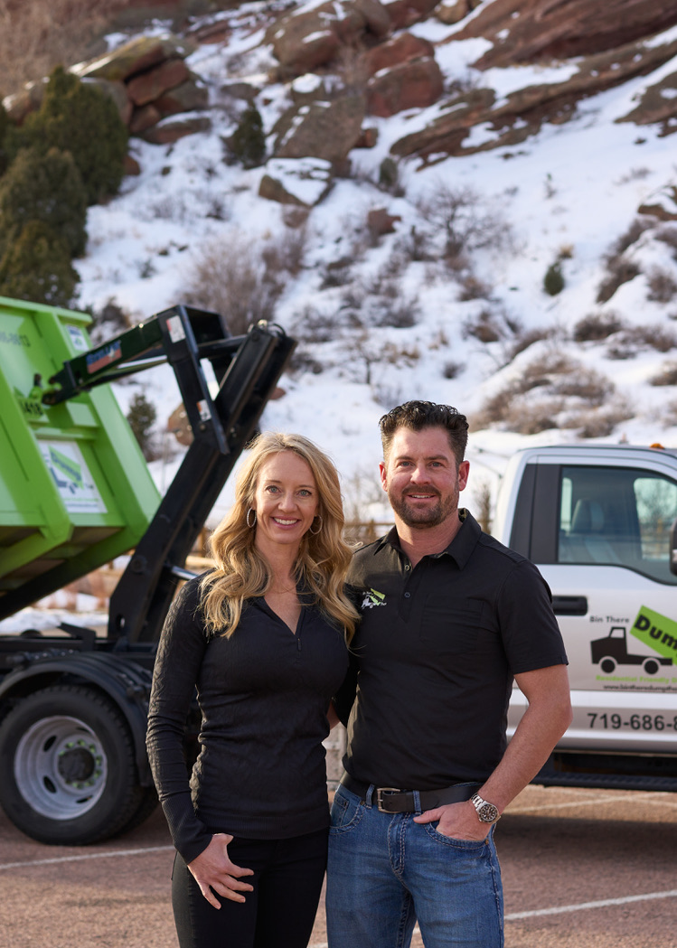 Brandon Dinkel with a green roll off dumpster and truck in the Colorado foothills