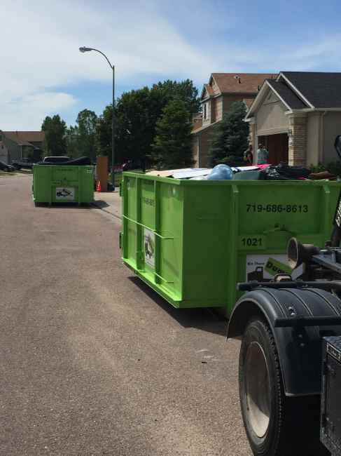 Dumpster loaded with furniture and household goods during a street cleanout