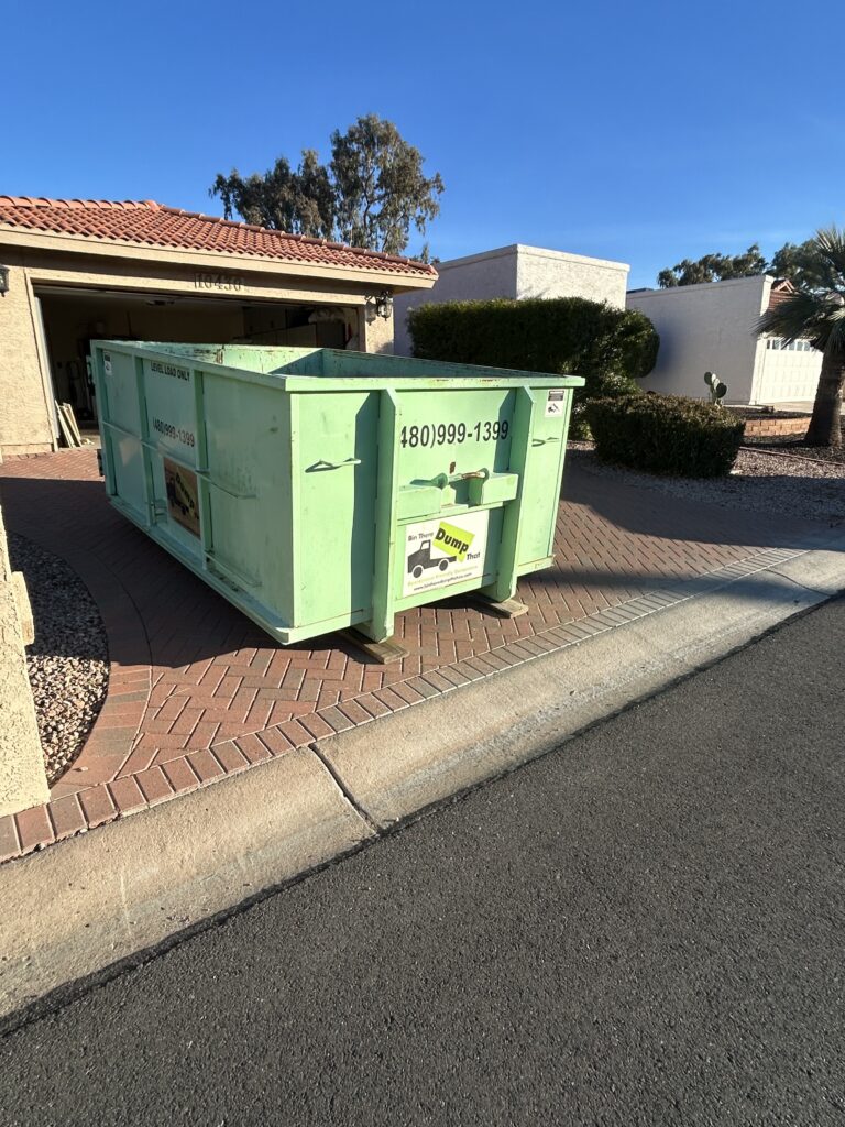 10-yard residential dumpster rental on a paver driveway in Sun Lakes, Arizona for a garage cleanout