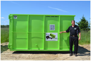 Mark Crossett, founder of Bin There Dump That, standing in front of 20 yard bin
