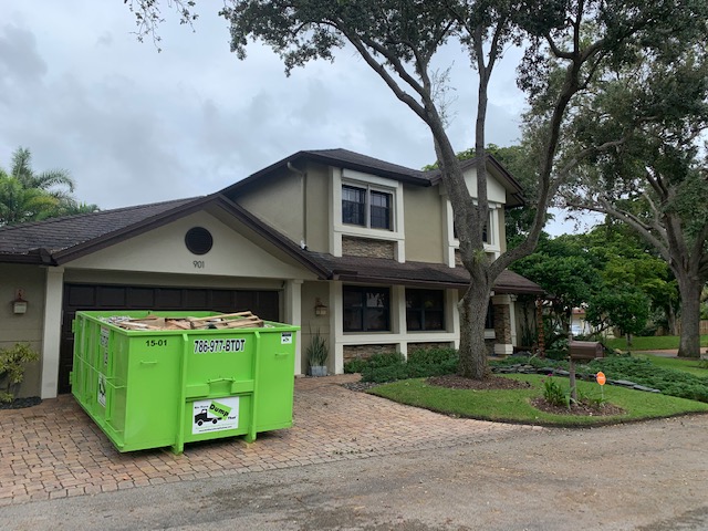 miami dumpster rental in residential driveway