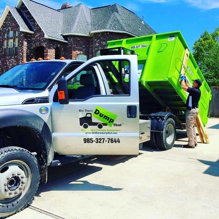 Green Dumpster on Driveway